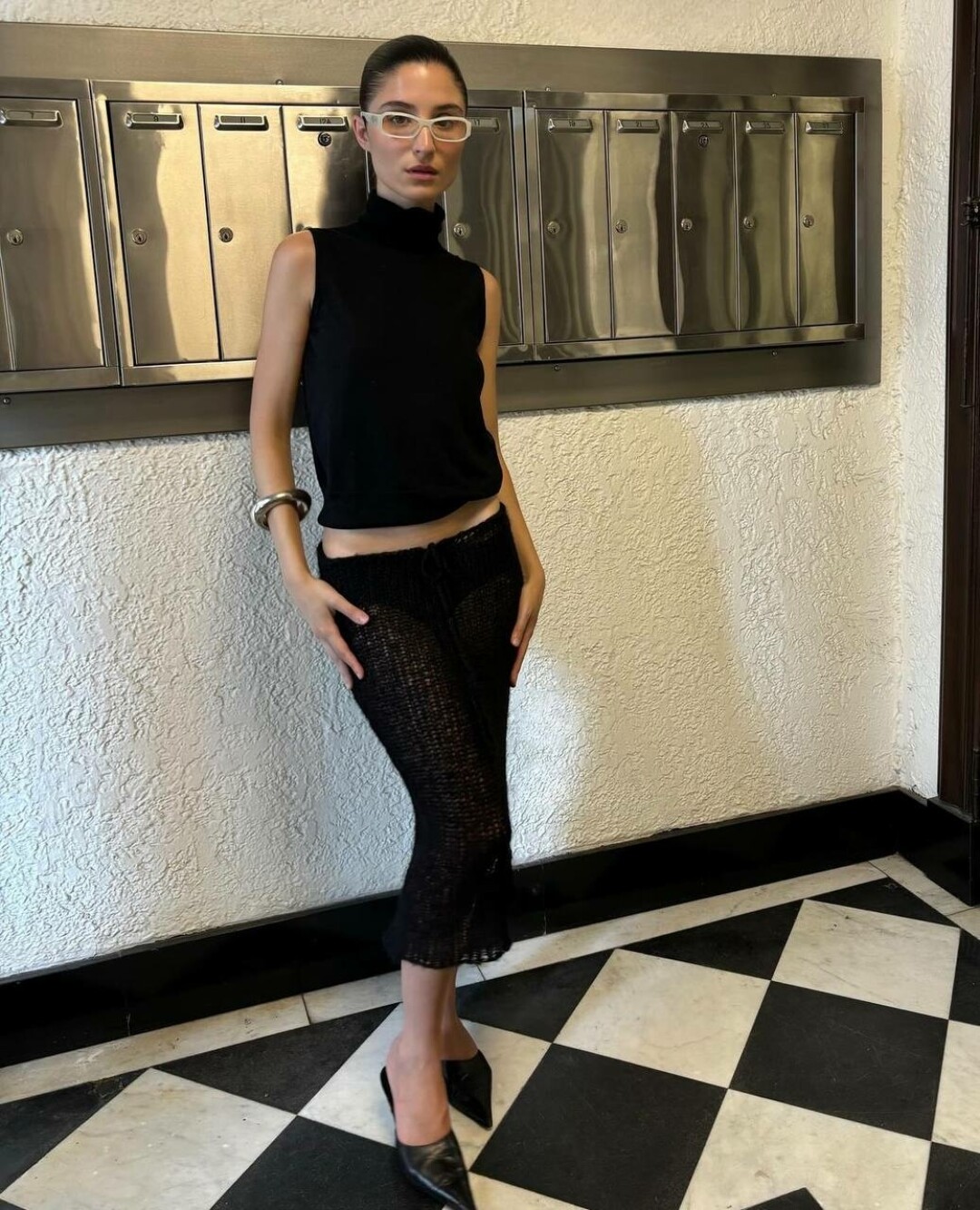 Андреа Риччи носит массивный серебристый браслет с лаконичным total black и оправой в духе офисных сирен