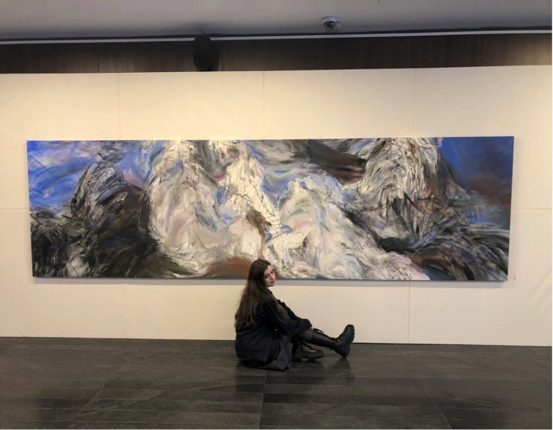 Анастасия Москалева на фоне своей работы «Танец». 2024