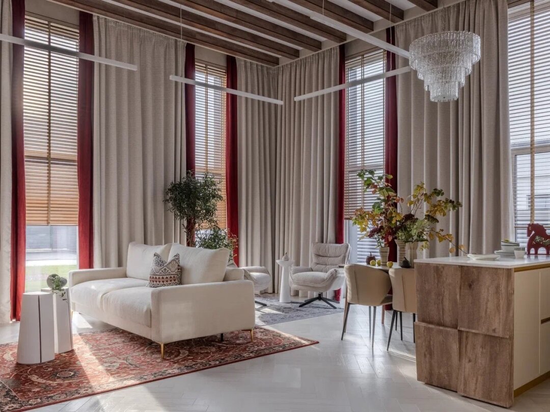 Гостиную украшает диван от Enza Home, а над обеденным столом разместили светильники от компании «Стили Света», обеденный стол – от Enza Home, бежевые