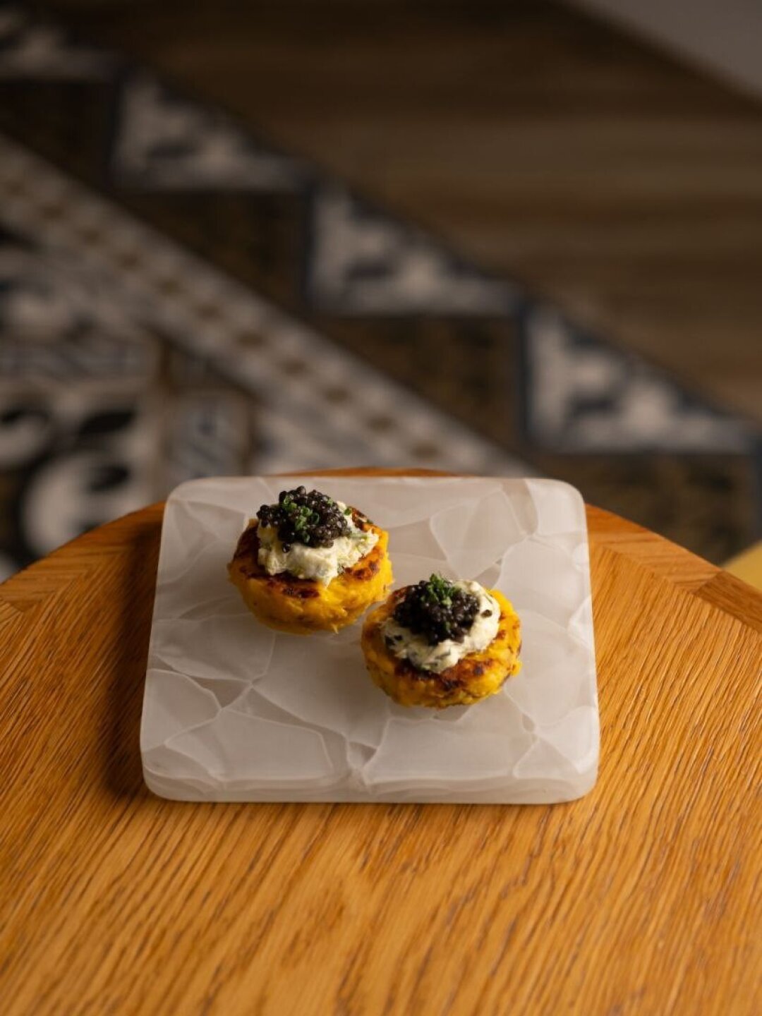 Тыквенные мини-оладьи с черной икрой в Nolan Wine&Kitchen