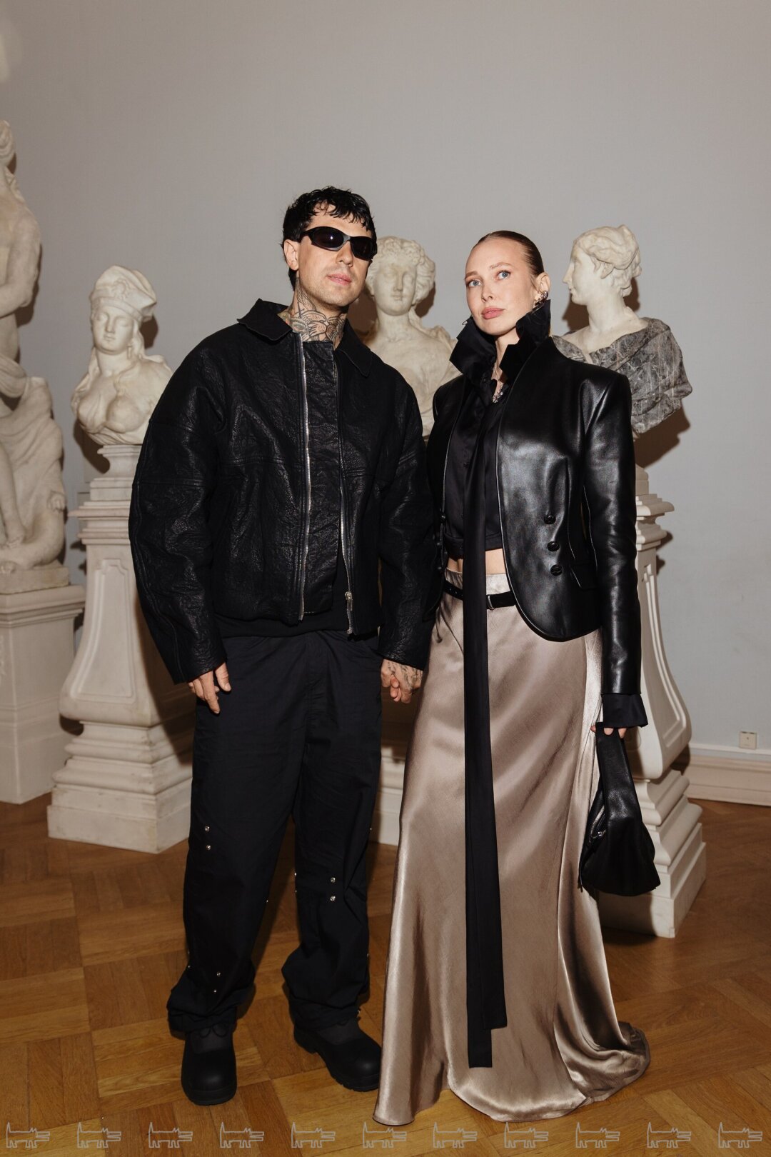 На Матвее: очки OAKLEY, кожаная куртка ARNODEFRANCE, брюки BRULER D'AMOUR, ботинки ROA На Кате: юбка, рубашка и пиджак SAINT-TOKYO, сумка BY FAR